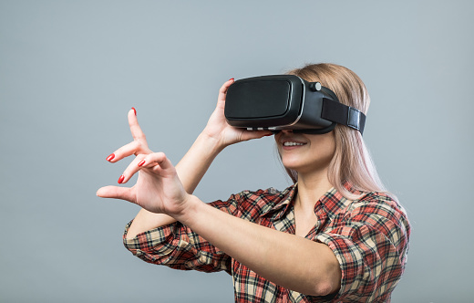 Young cheerful woman with vr headset