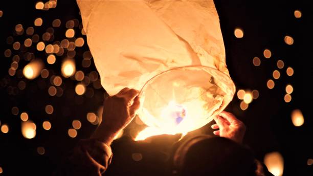 istock Close-Up Of Hand Holding Illuminated Paper Lantern At Night 903692138