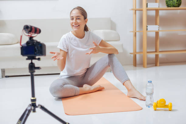 istock Emotional blogger smiling while addressing her viewers 903697044
