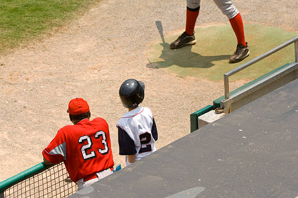 istock Baseball Player and Baseball Coach standing in dugout at a Baseball Game 90369879