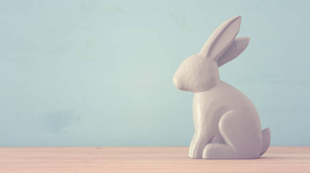 istock Cute wooden bunny over colorful background. 903702012