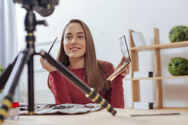 istock Enthusiastic beautiful woman smiling to the camera while holding a brush 903703018