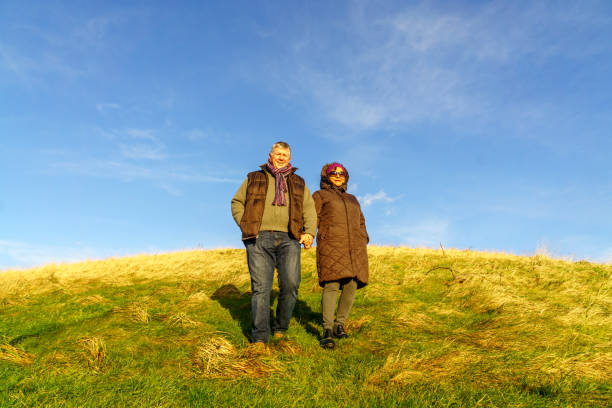 istock Senior couple walking on countryside path in winter 903711108