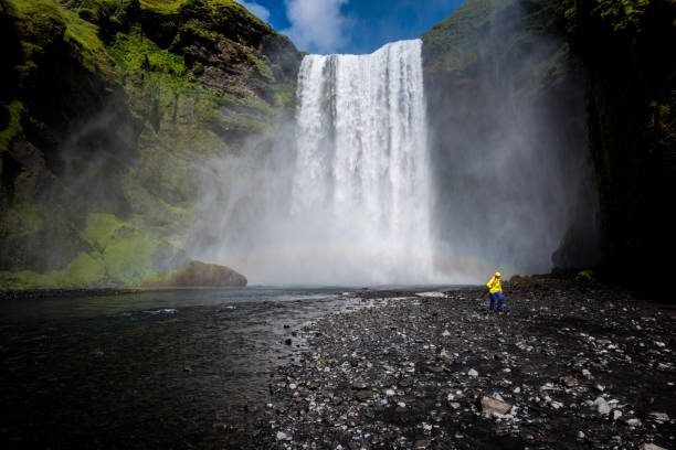 istock Woman in front of waterfall 903711740