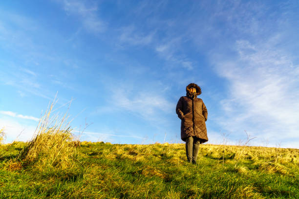 istock Senior Hispanic woman walking on countryside path in winter 903712134