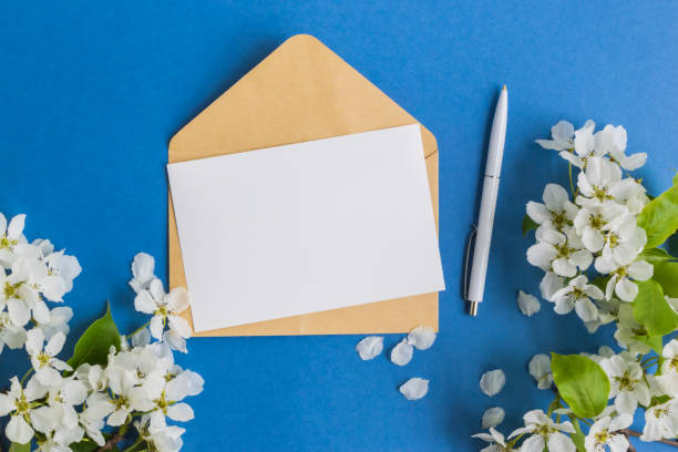 istock Mockup white greeting card with white spring flowers 903712874