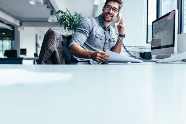 Businessman talking on landline phone