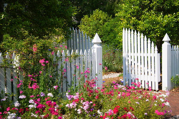 Beautiful Garden with open white gate stock photo