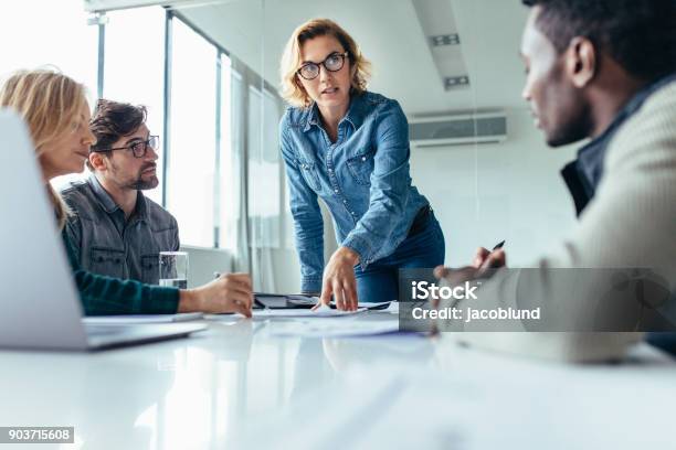 Businesswoman Leading Business Presentation Stock Photo - Download Image Now - Leadership, Meeting, Manager