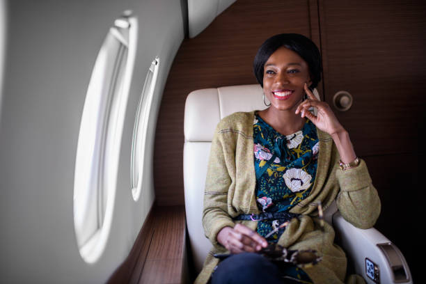 istock Woman in private jet airplane 903718132