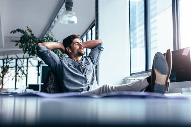 istock Male designer sitting relaxed at his workplace 903718592