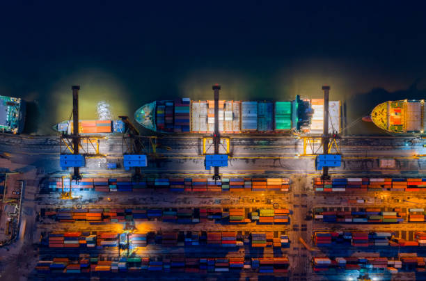 istock Containers yard in port congestion with ship vessels are loading and discharging operations of the transhipments in international port. 903720404