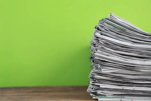 Photo of close up newspapers folded and stacked background on the table