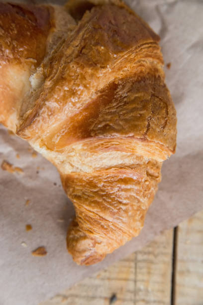 istock Fresh croissant lies on paper 903730962