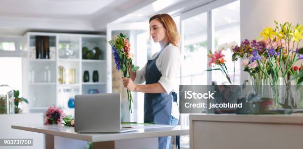 Female Florist At Work Creating A Bouquet Stock Photo - Download Image Now - Small Business, Laptop, Owner