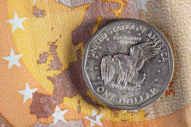 makro pieniądz walutowy: 1 moneta dolara amerykańskiego na 50 banknotach euro - european union coin flash zdjęcia i obrazy z banku zdjęć