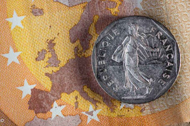 Currency money macro: French franc coin on 50 Euro banknote