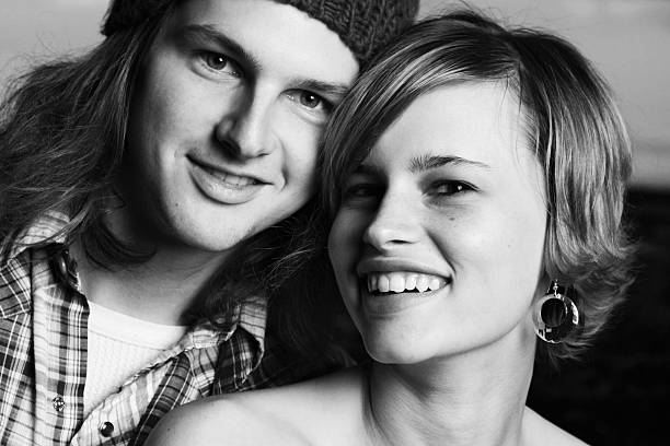 Black and white portrait of young sweethearts isolated on white background.