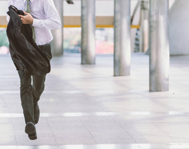 businessman hurry running Stressed anxious businessman in a hurry and running, he is late for his business appointment and Wear a shirt while running. oversleeping stock pictures, royalty-free photos & images