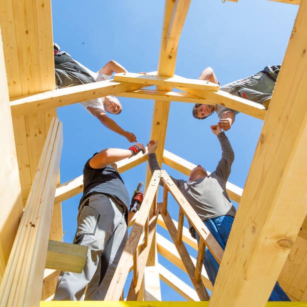 istock Builders at work with wooden roof construction. 903744454