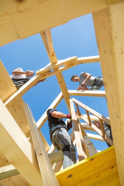 istock Builders at work with wooden roof construction. 903744602