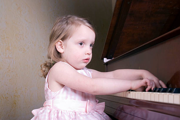 Piano practice  girl playing piano stock pictures, royalty-free photos & images