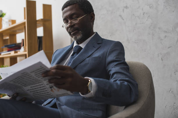 istock Businessman reading newspaper 903759144