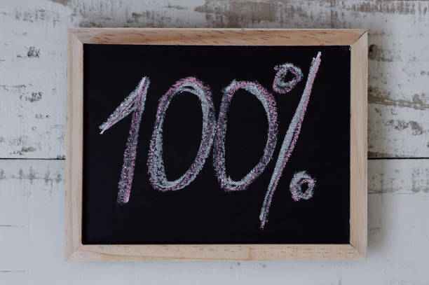 istock 100 percent. 100% written on blackboard, top view. One hundred 903759738
