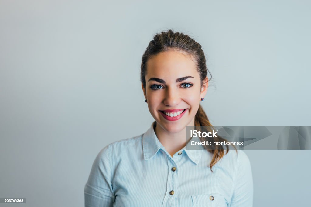 Studio shot of young woman looking at camera. Adult Stock Photo