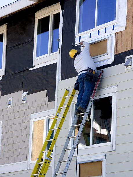 Man Hanging Siding - Construction stock photo