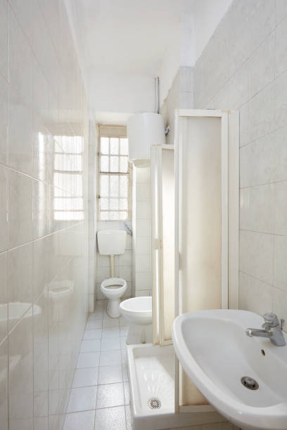 istock Old bathroom interior with tiled floor and walls 903764968