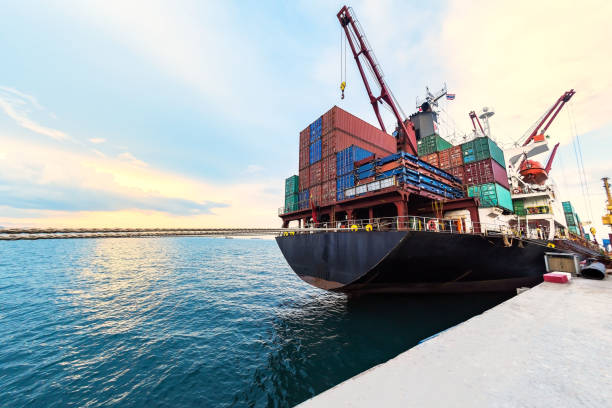 container ship commercial vessel alongside in port for loading and discharging containers services in maritime transports in World wide logistics