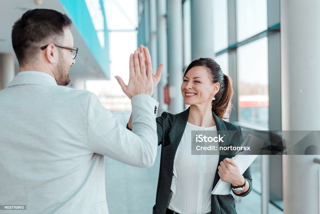 Two excited business colleagues team give high five. High-Five Stock Photo