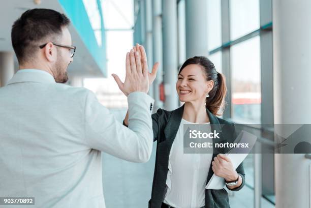 Two Excited Business Colleagues Team Give High Five Stock Photo - Download Image Now