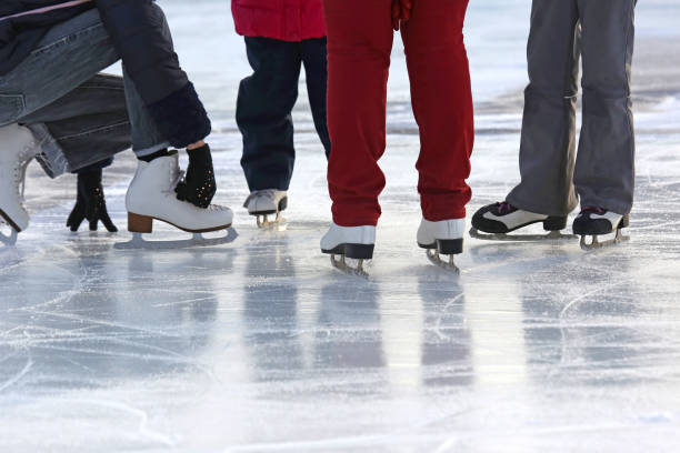 istock people together skating on the ice rink 903778098