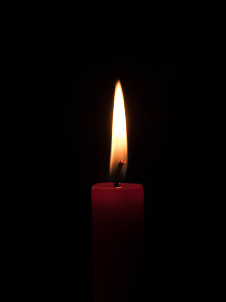 istock flame of a candlelight in the darkness 903792072