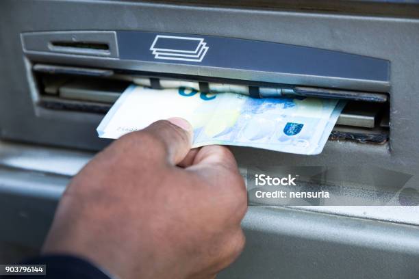 Close Up Of Man Taking Cash From Atm With Credit Card Stock Photo - Download Image Now