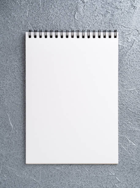 istock blank sheet of notebook with a spiral on a neutral gray textured silver metallic background 903796164