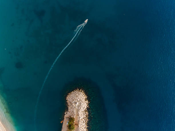 istock Bird's eye view of Lighthouse and a Boat 903803052