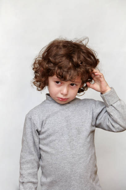 istock Frowning child touching hair 903808670