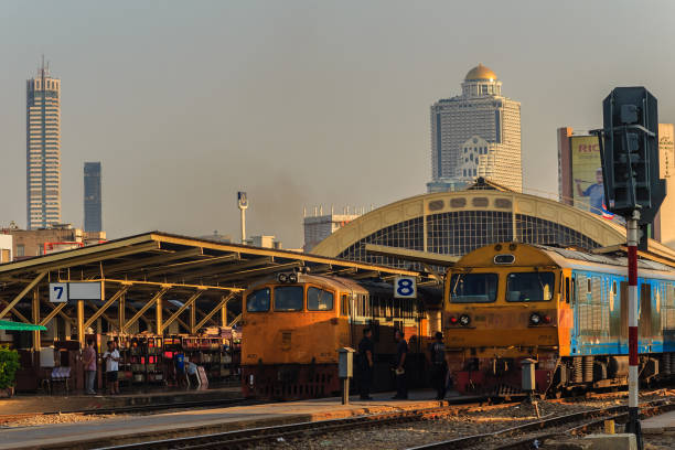 Bangkok, Thailand - April 23, 2017: The train is leaving the station while the staff command by flags and walky-talky radio at Hua Lamphong railway station.