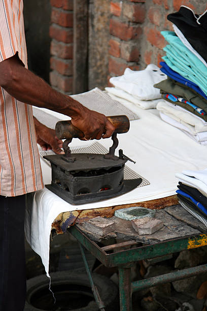 istock Man Ironing Clothes in India 90381906