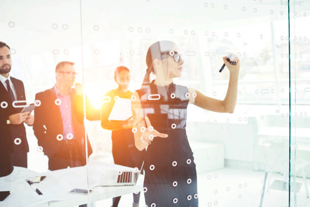 istock Professional assistant of businessman helping with conference preparation writing on board planning of event, talented female architect presenting her project making drawings for illustrate idea 903819436