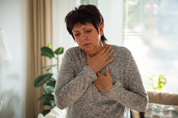 istock Sick mature woman with sore throat 903822586