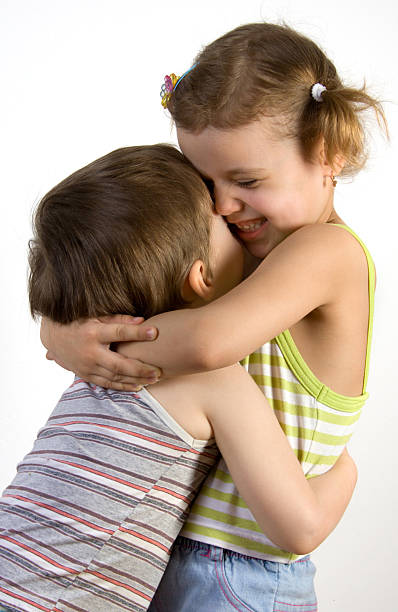 istock Smiling girl embraces a little boy 90382461