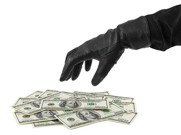 Photo of Hand in glove and money