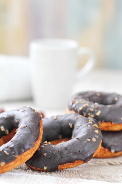istock Chocolate doughnuts with chocolate glaze pouring over 903829906