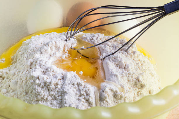 istock Raw egg in flour and metal whisk 903830640