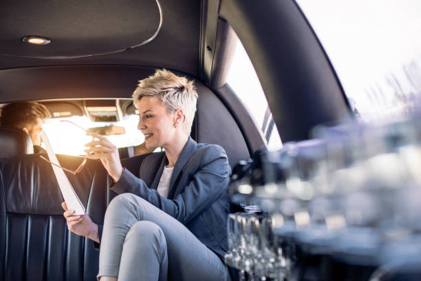 istock Business woman in limousine looking at documents 903830892