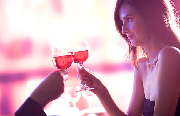 Young couple celebrating with red wine together stock photo